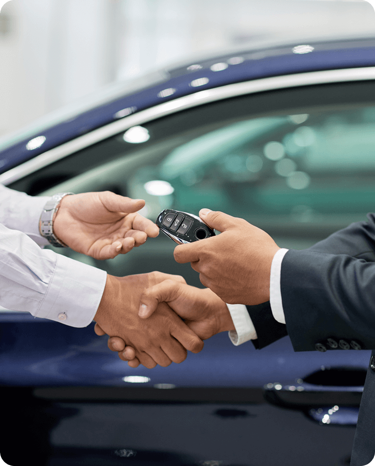 Handshake and car keys exchange by vehicle.