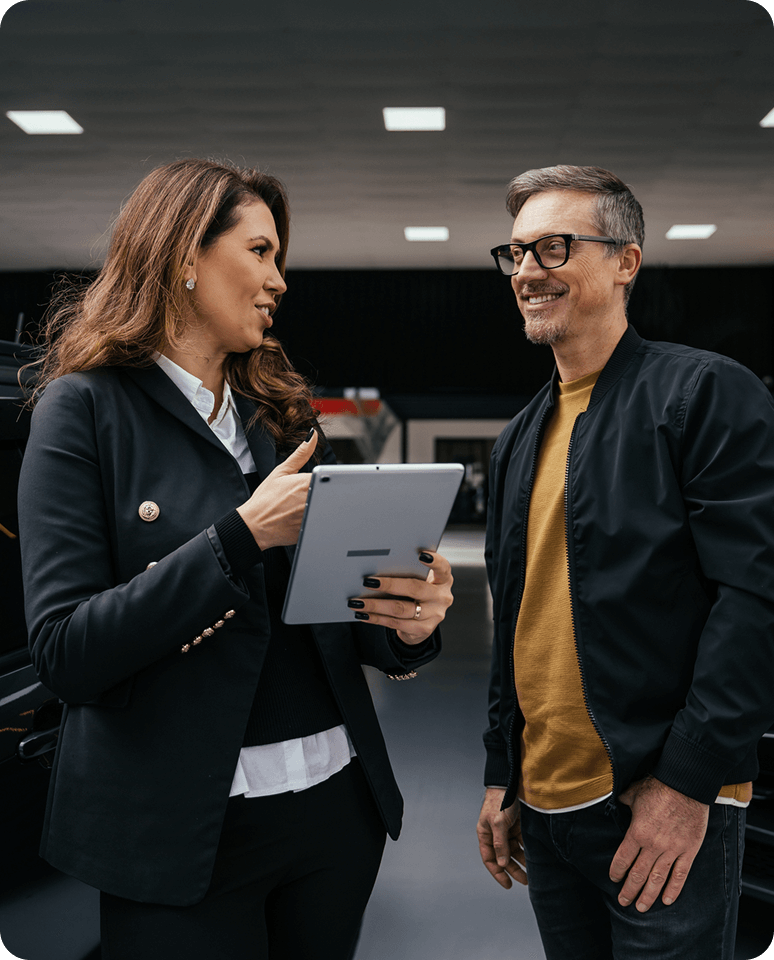 Two people discussing with a tablet.